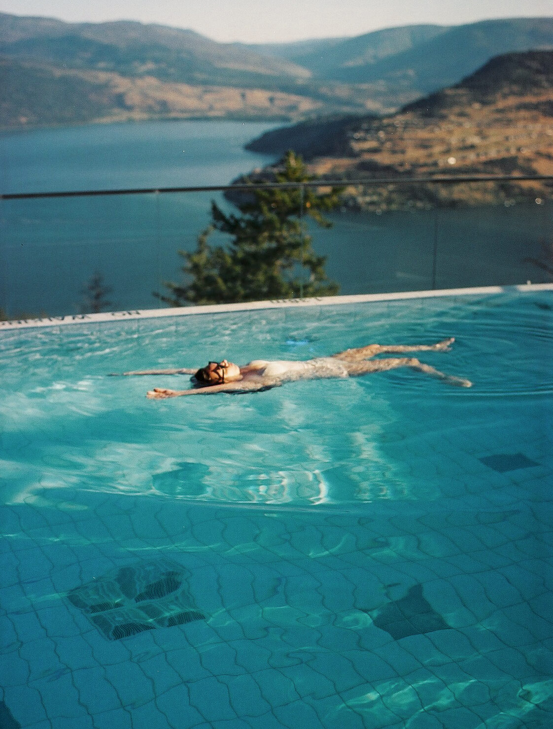 Woman floating in the pool at Sparkling Hill Resort