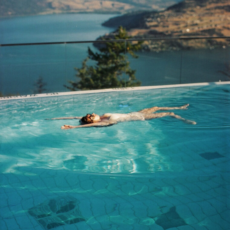 Woman floating in the pool at Sparkling Hill Resort