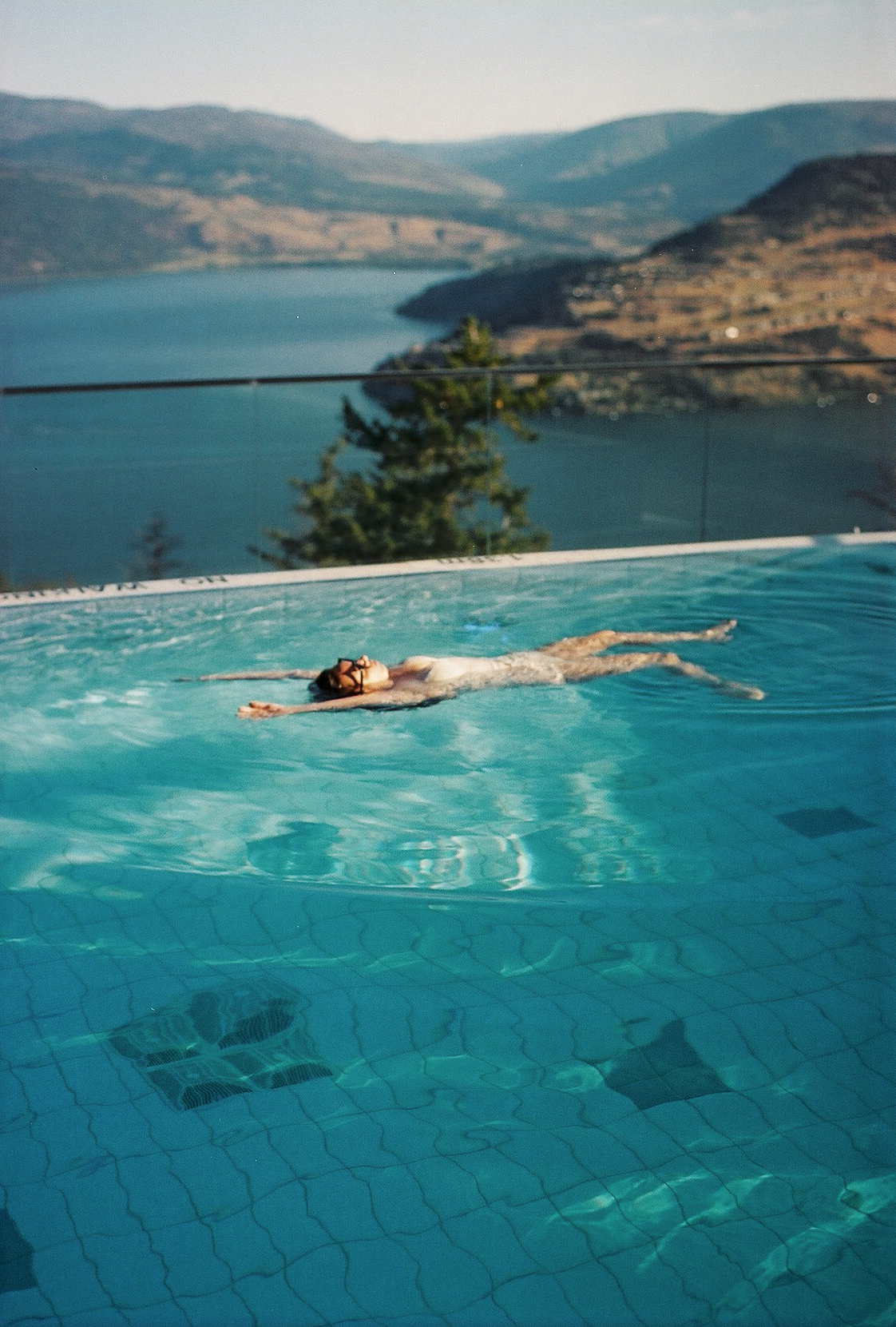 Woman floating in the pool at Sparkling Hill Resort
