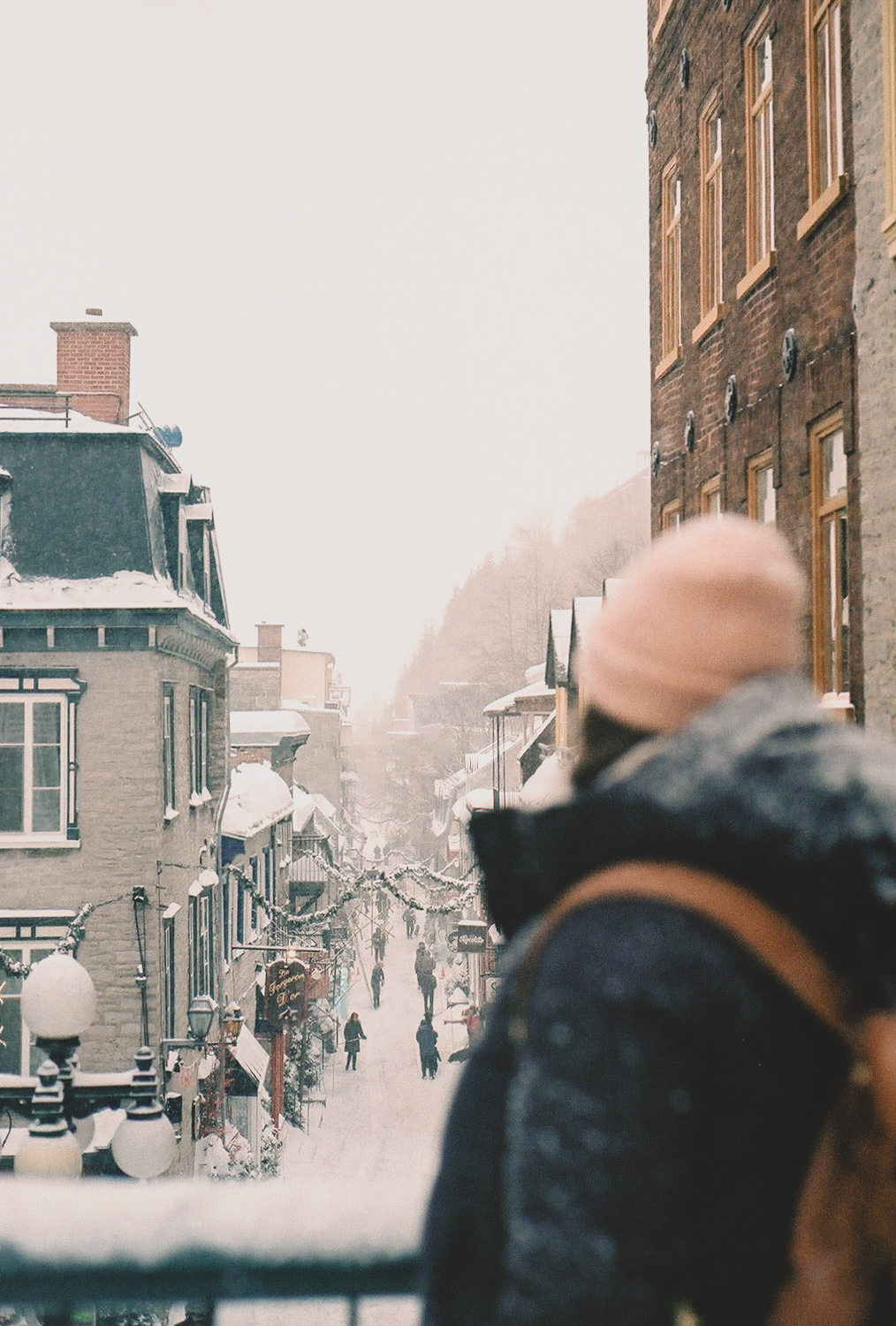 Woman walking through snowy Old Québec on a winter day