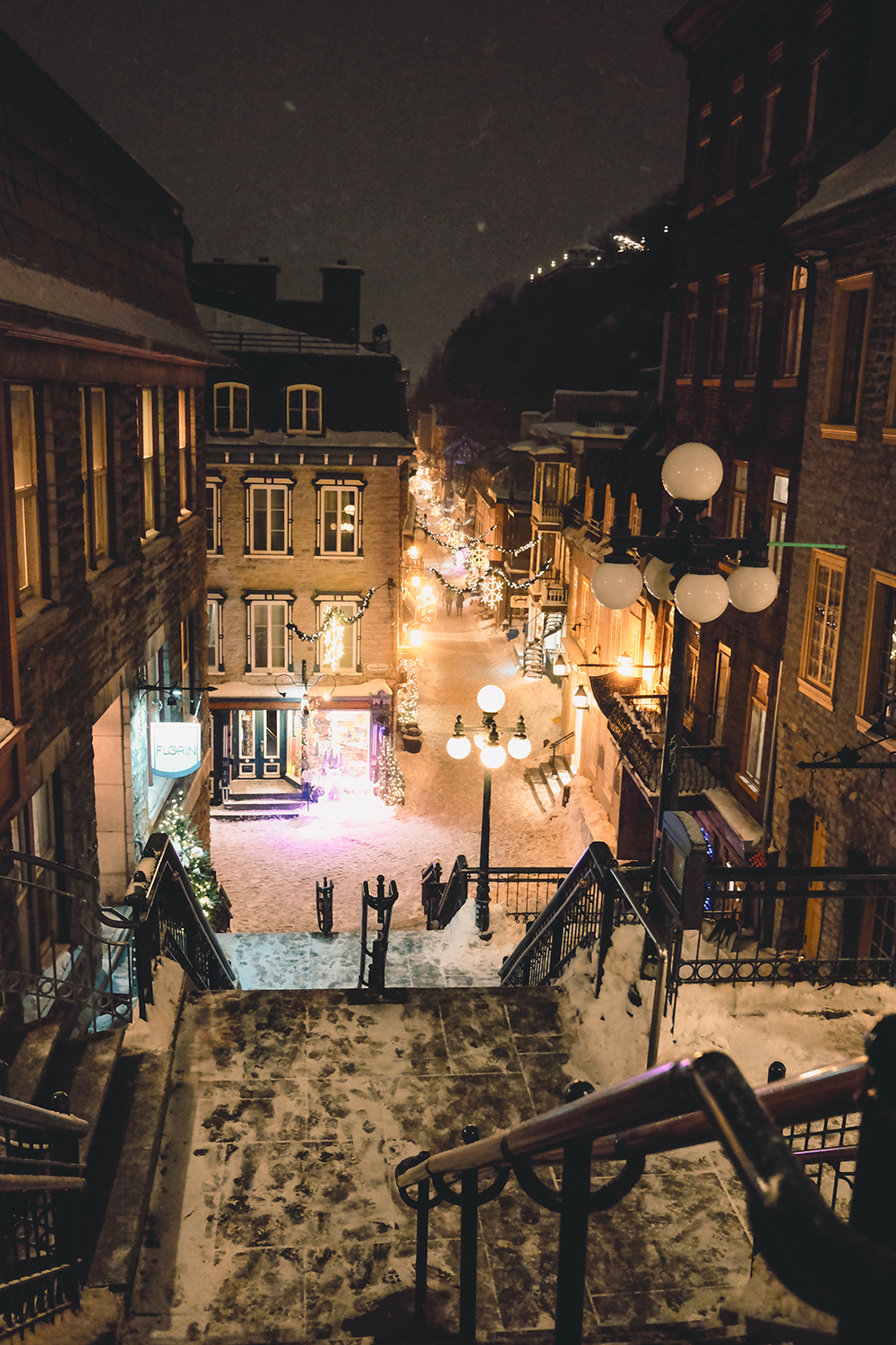 Snowy Old Québec street lit at night in winter
