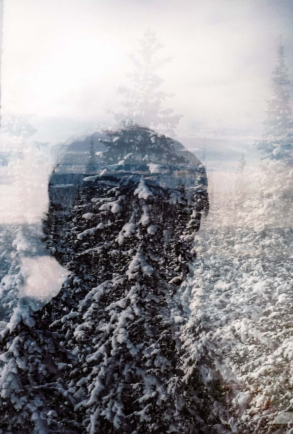 Child looking through a snow-covered window during a SilverStar winter trip