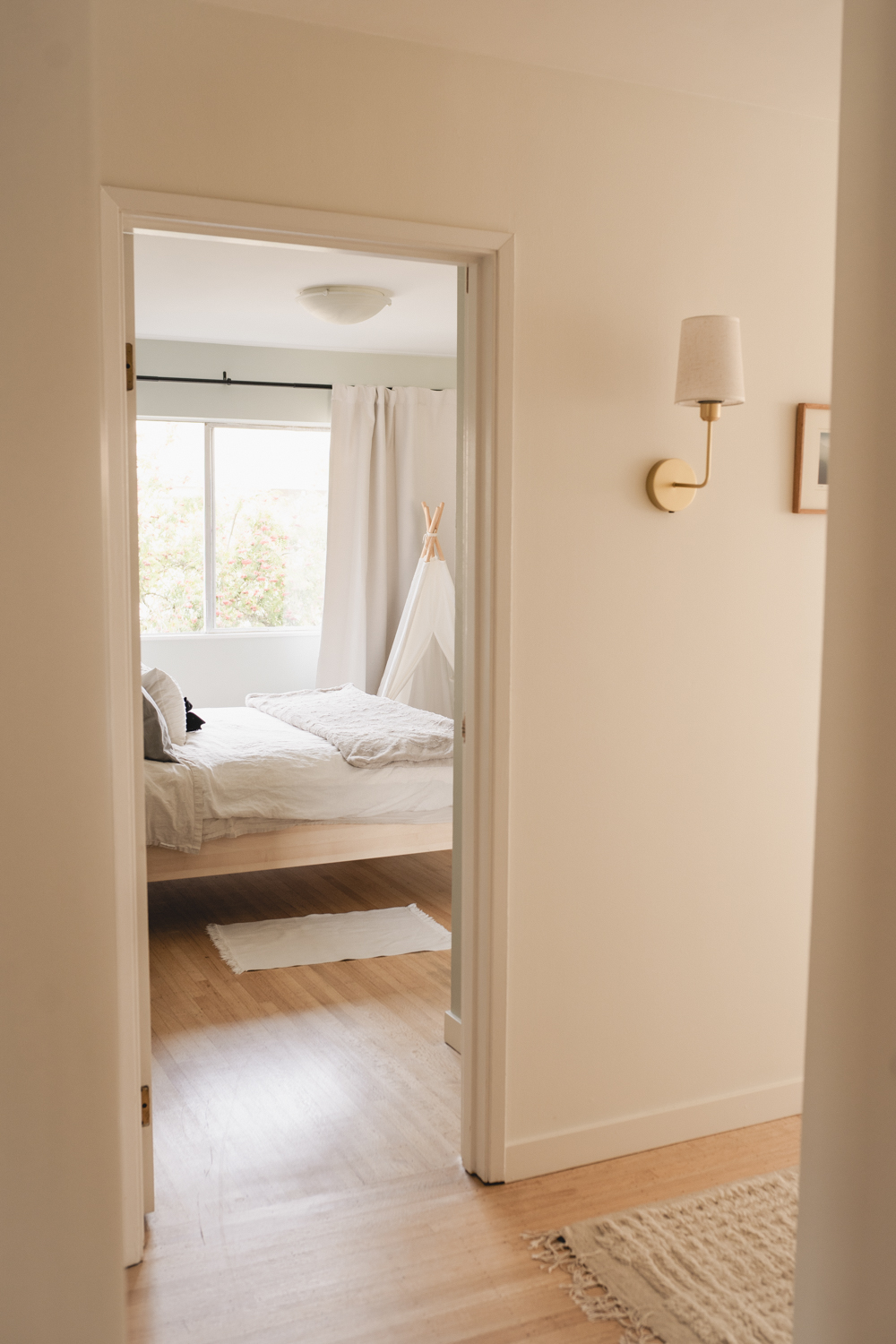 Freshly painted hallway leading into a finished bedroom in a Vancouver home
