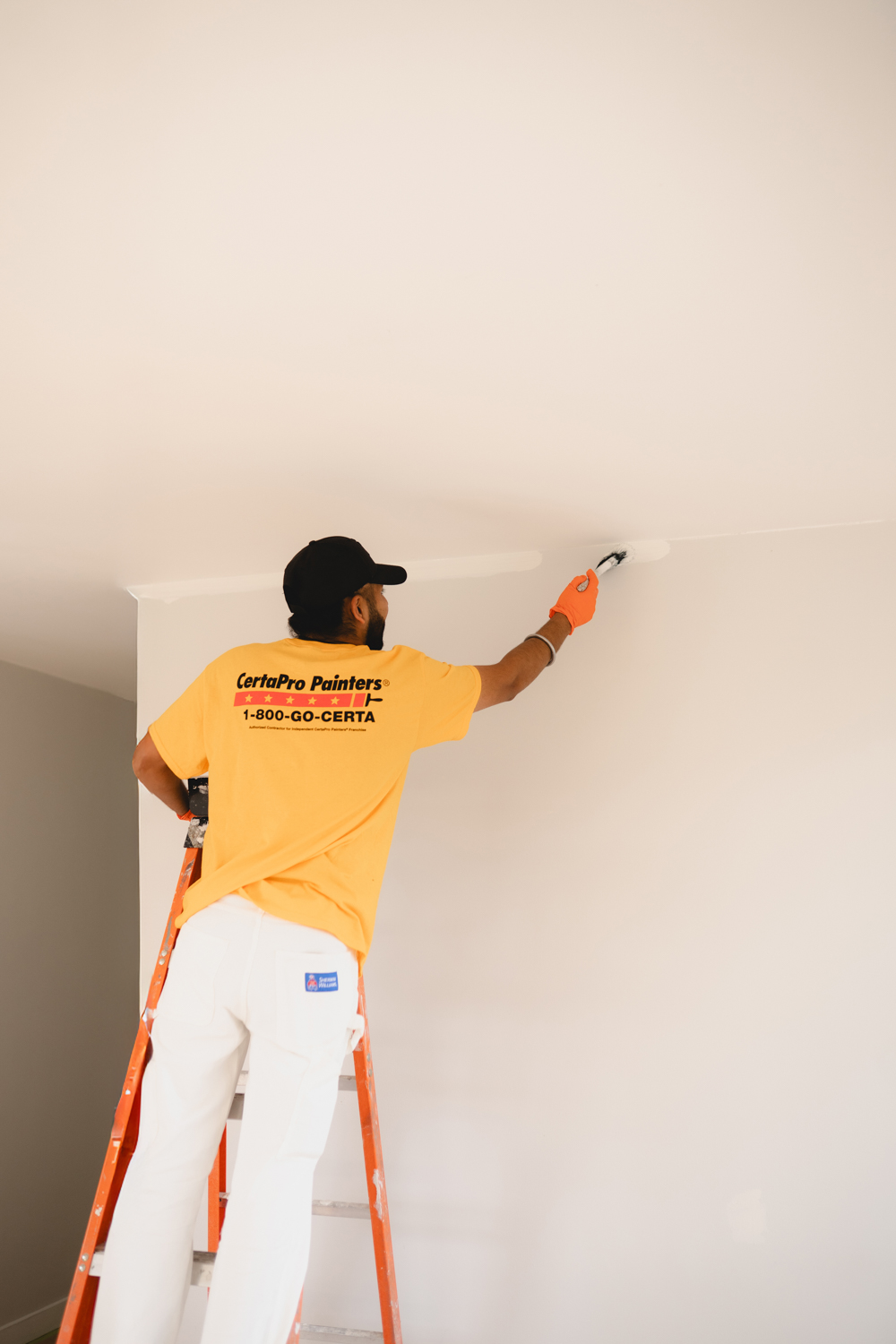 Professional residential painter applying fresh paint to an interior wall in Vancouver