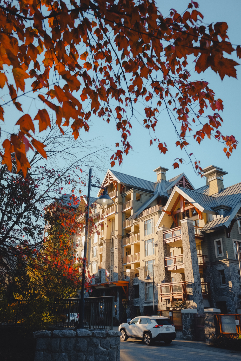 Whistler Village framed by colourful fall leaves